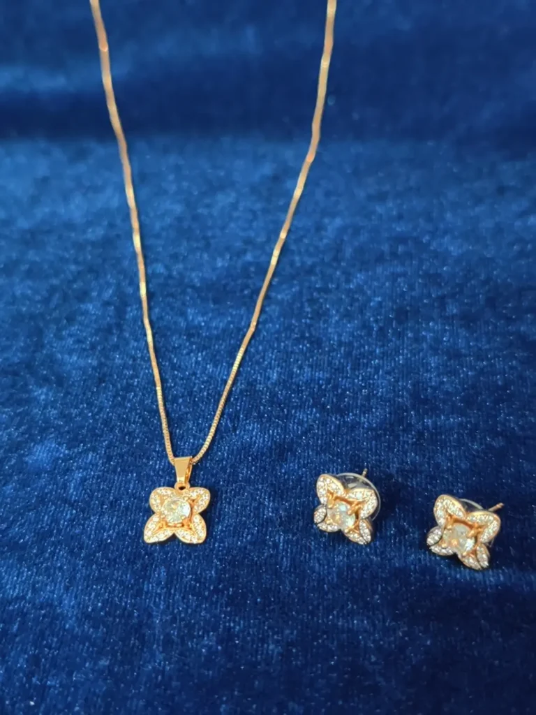 Charming flower-shaped stud earrings featuring four sparkling petal-like sections and a prominent central crystal